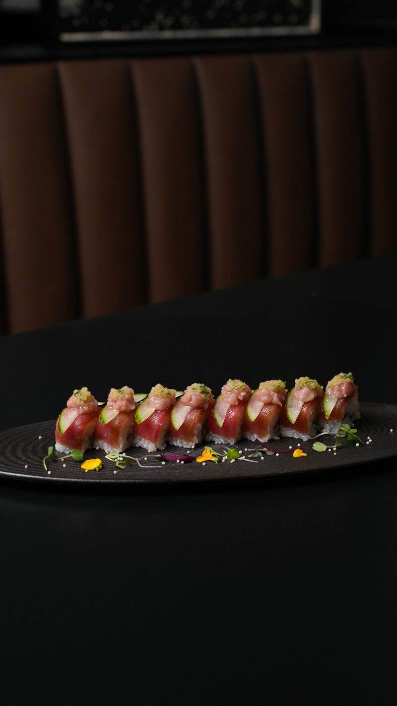 Tuna oshi sushi with cucumber and edible flowers