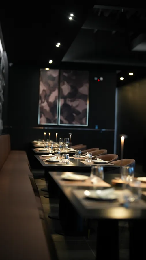 Well-lit rear dining area with set tables and upholstered seating