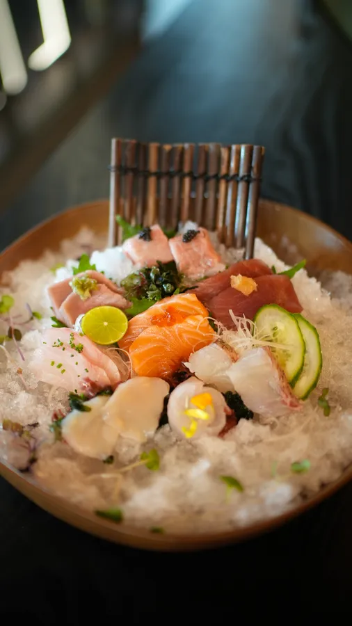 Sashimi Omakase with assorted salmon, tuna, white fish, and scallop arranged over crushed ice