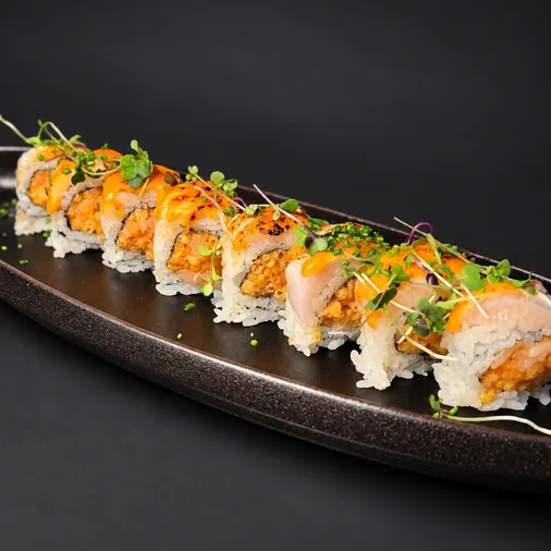 Toyosu Maki with seared fish and chives on a black platter